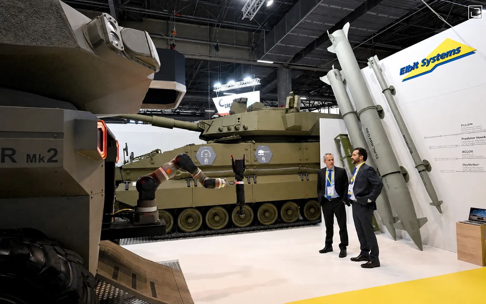 Israeli defense technology company Elbit Systems staff stand on the booth at the Eurosatory, in Villepinte, Paris, June 13, 2022. (AFP Photo)